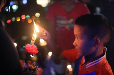A student (Ken) at the Redemptorist Center in Pattaya, Thailand, lights his teacher's krathong for Loy Krathong A student (Ken) at the Redemptorist Center in Pattaya, Thailand, lights his teacher's krathong for Loy Krathong