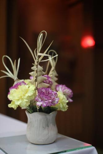 Flowers, palms, and a slight echo of knives and thorns: all for the King of Israel, who both cannot be wounded and can